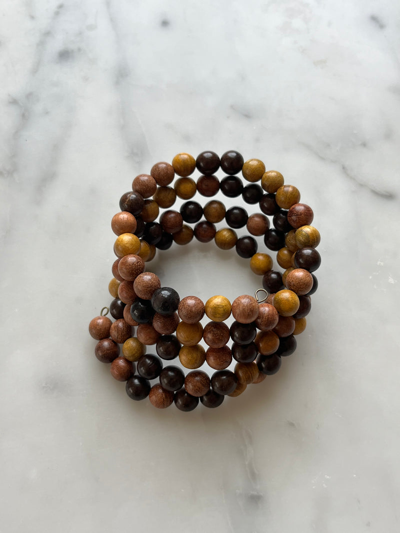 A beaded bracelet with a variety of brown and black beads